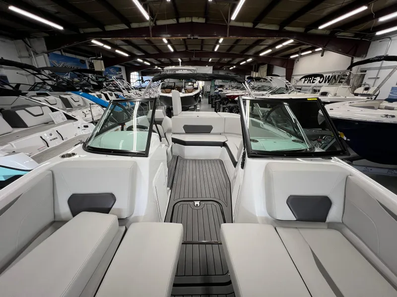 Slide: The Image of 2024 Hurricane SunDeck 187 IO boat interior in showroom, featuring sleek seating and modern design. - 12