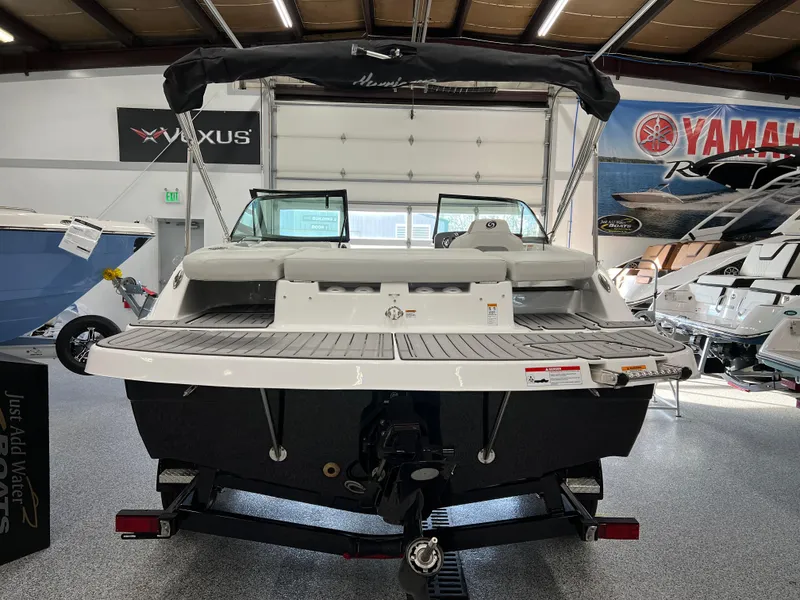 Slide: The Image of 2024 Hurricane SunDeck 187 IO boat displayed in showroom, rear view with trailer attachment. - 3