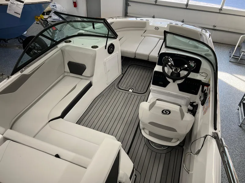 Slide: The Image of 2024 Hurricane SunDeck 187 IO boat interior with sleek seating and modern dashboard. - 6