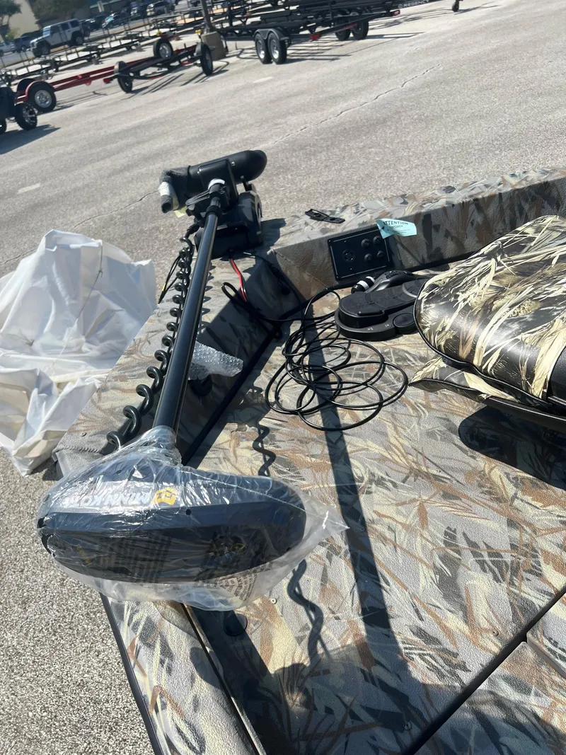 Slide: The Image of 2024 Ranger RB190 boat with camo seats and trolling motor. - 2