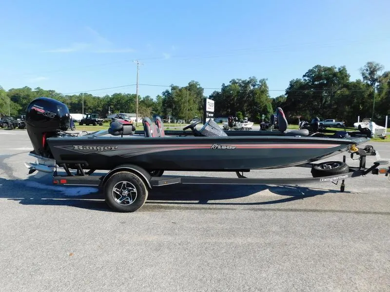 Slide: The Image of 2024 Ranger RT198P fishing boat on a trailer in a parking lot. - 1