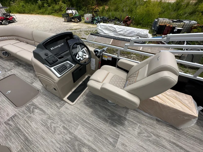 Slide: The Image of 2024 Ranger Reata 223C boat interior with captain's chair and control console. - 14