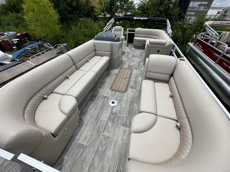 Slide: The Image of 2024 Ranger Reata 223C pontoon boat with spacious seating and modern design. - 5