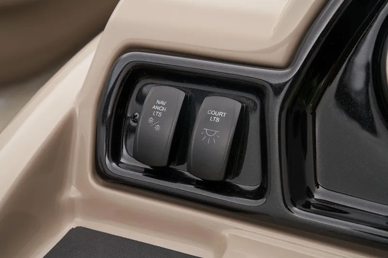 Slide: The Image of 2024 Ranger Reata 200C boat control panel with navigation and court lights switches. - 34