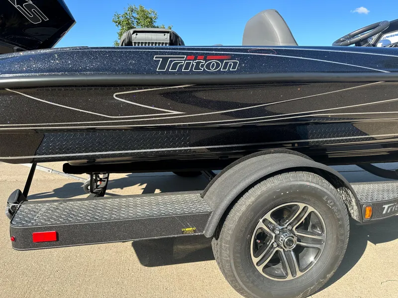 Slide: The Image of 2024 Triton 18 TrX boat on trailer, black with sleek design. - 3