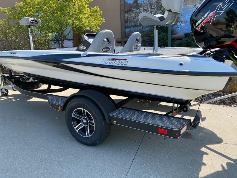 Slide: The Image of 2024 Triton 179 TrX fishing boat on trailer with Mercury engine. - 2