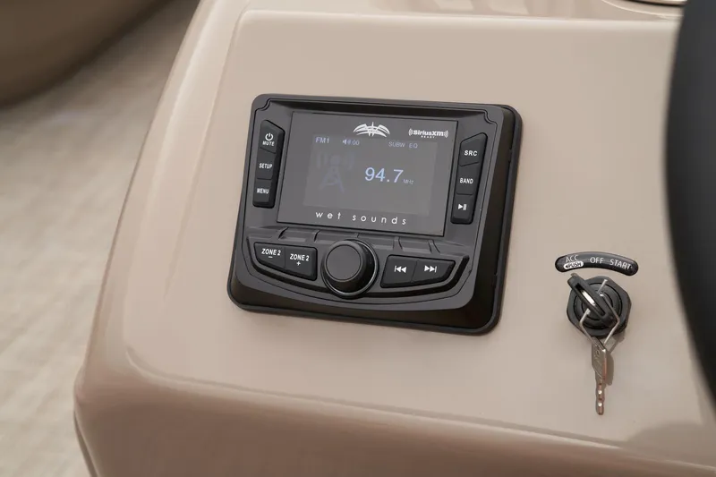 Slide: The Image of 2024 Ranger Reata 200C boat dashboard with stereo system and ignition key. - 36