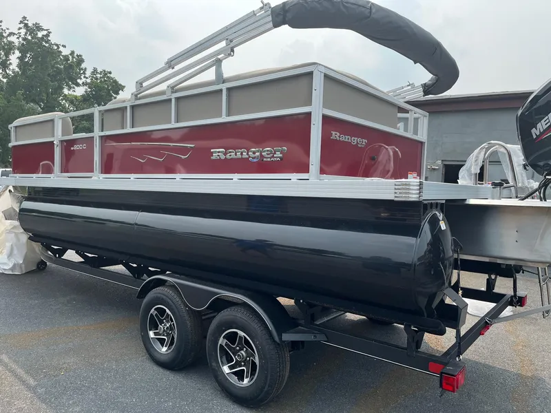 Slide: The Image of 2024 Ranger Reata 200C pontoon boat on a trailer. - 4