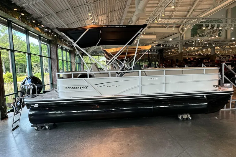 Slide: The Image of 2024 Ranger Reata 223C pontoon boat displayed indoors. - 0