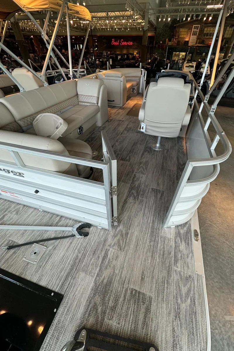 Slide: The Image of 2024 Ranger Reata 223C pontoon boat interior with seating and flooring. - 2