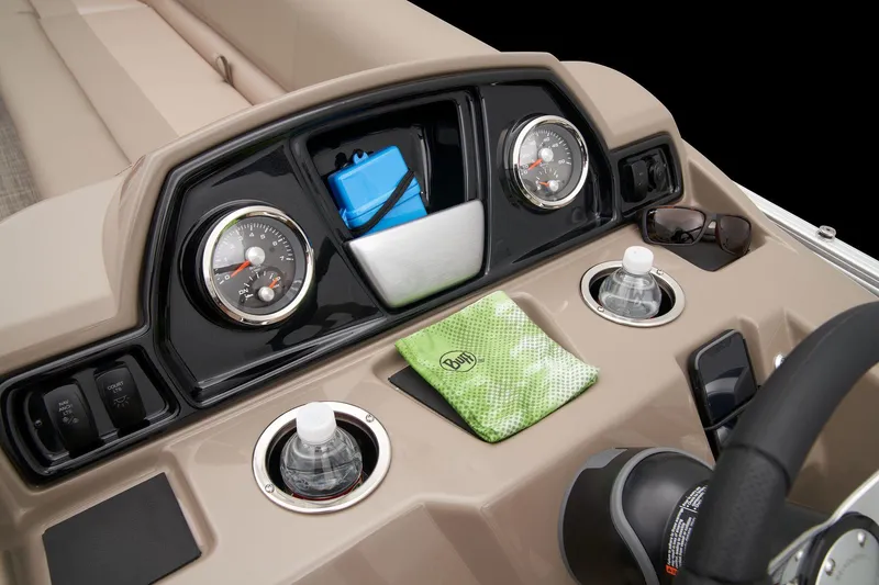 Slide: The Image of 2024 Ranger Reata 200C boat dashboard with gauges, cup holders, and storage compartments. - 28