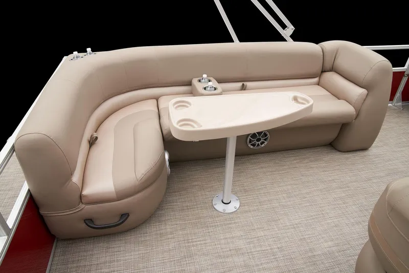 Slide: The Image of 2024 Ranger Reata 200C boat interior with beige seating and table. - 36