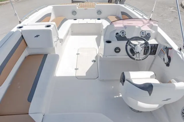 Slide: The Image of 2022 Starcraft SVX 171 OB boat interior with seating and steering console. - 15