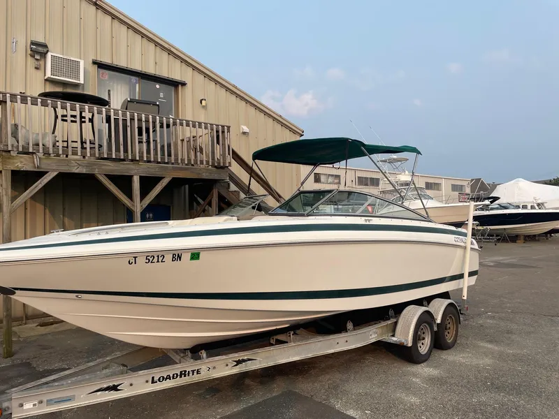 The Image of 1998 Cobalt 252 boat on a Load Rite trailer outside a storage facility. - 0