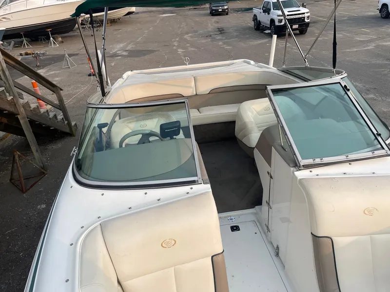 Slide: The Image of 1998 Cobalt 252 boat interior with white seating and steering wheel. - 17