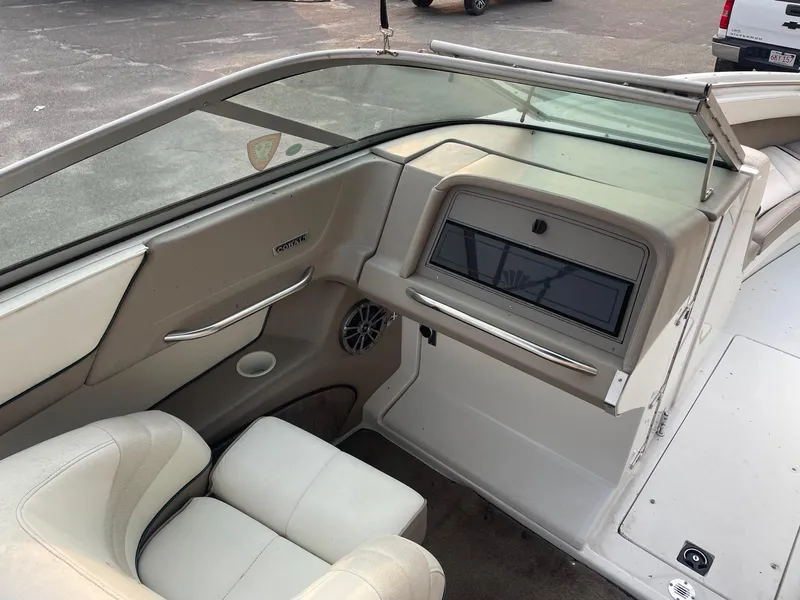 Slide: The Image of 1998 Cobalt 252 boat interior with beige seating and dashboard. - 20