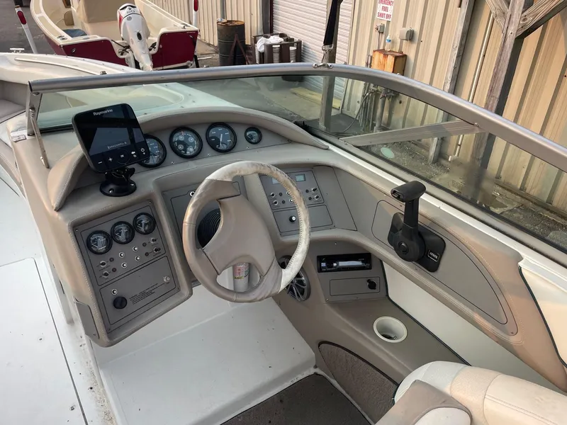 Slide: The Image of 1998 Cobalt 252 boat dashboard with steering wheel and control panel. - 22