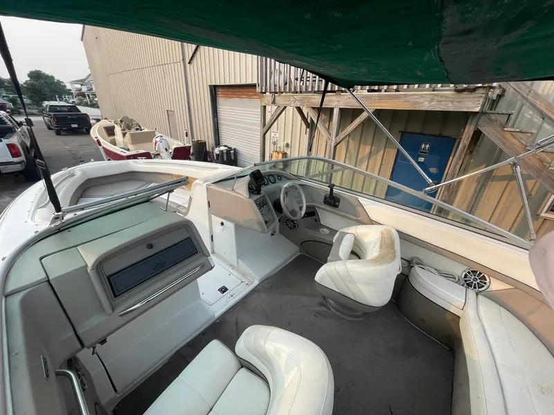 Slide: The Image of 1998 Cobalt 252 boat interior with white seating and dashboard. - 26