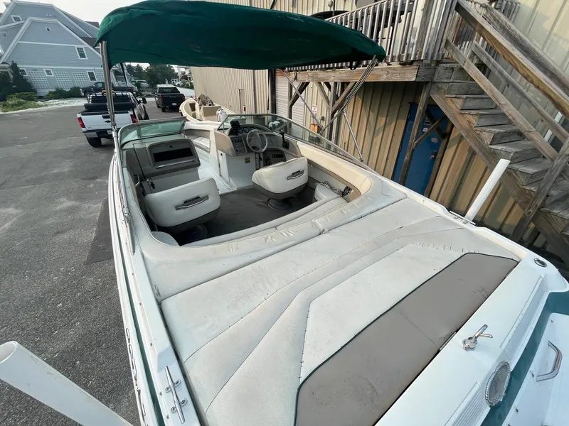 Slide: The Image of 1998 Cobalt 252 boat with green canopy and spacious seating. - 29