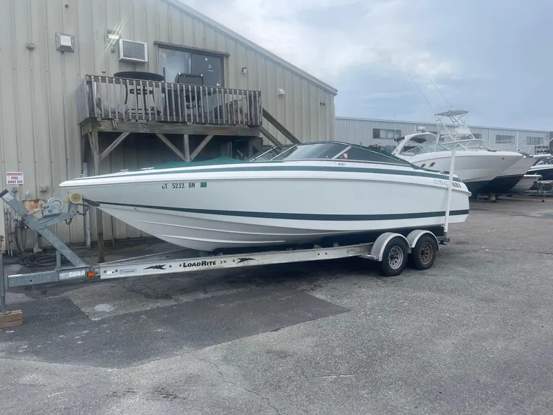 Slide: The Image of 1998 Cobalt 252 boat on a trailer in a marina parking lot. - 4