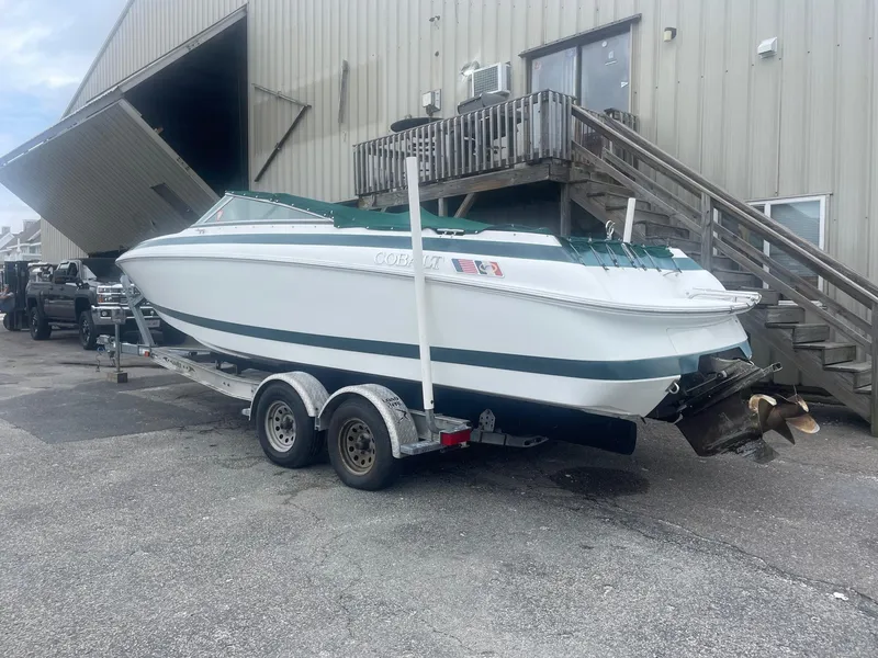 Slide: The Image of 1998 Cobalt 252 boat on a trailer outside a warehouse. - 6