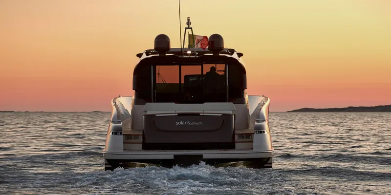 Slide: The Image of 2024 Solaris 57 Lobster yacht cruising at sunset on open water. - 2