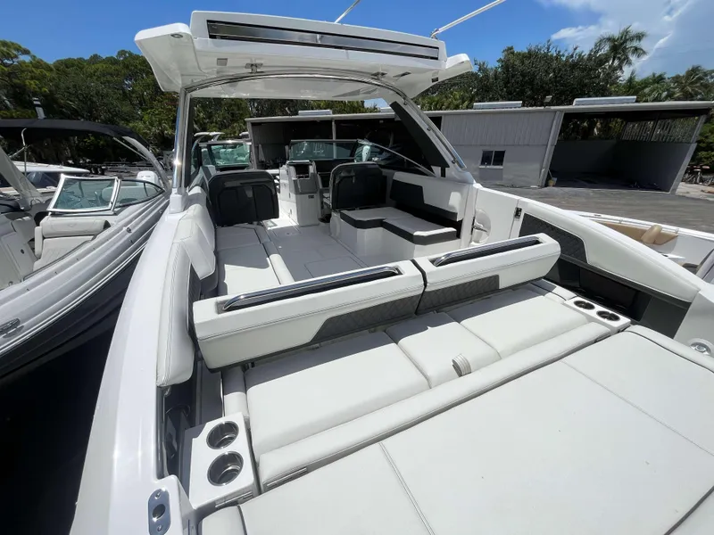 Slide: The Image of 2023 Cobalt R33 boat interior with white seating and modern design. - 14