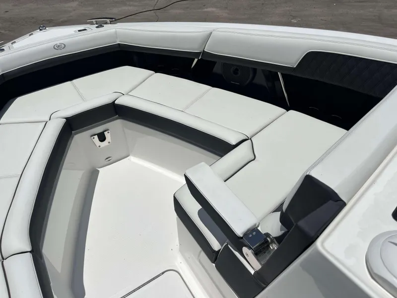 Slide: The Image of 2023 Cobalt R33 boat interior with white cushioned seating. - 4