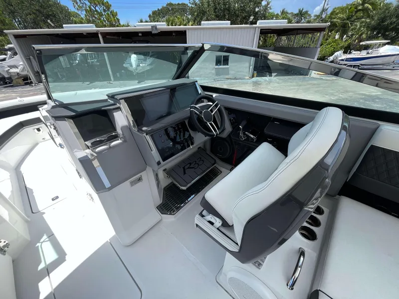Slide: The Image of 2023 Cobalt R33 boat cockpit with modern steering and dashboard controls. - 7