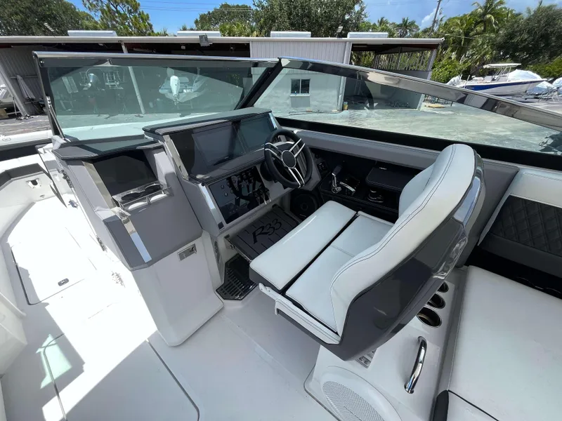 Slide: The Image of Interior of 2023 Cobalt R33 boat with modern dashboard and steering wheel. - 8