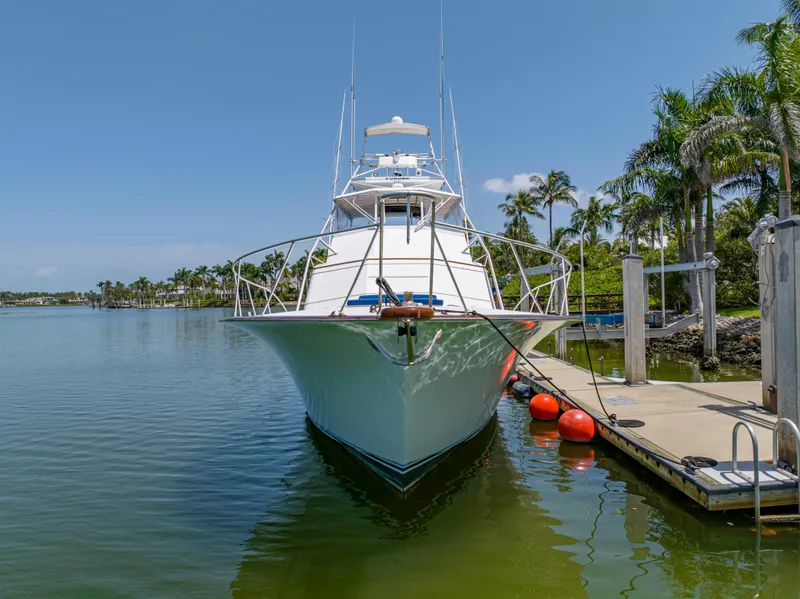 Slide: The Image of 1990 Buddy Davis 61 Convertible yacht docked in a tropical marina. - 1
