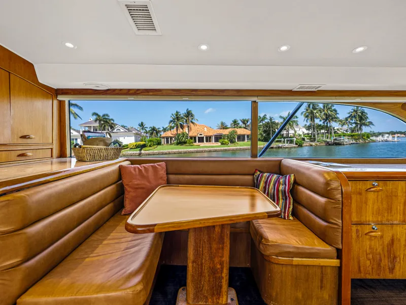 Slide: The Image of Interior of 1990 Buddy Davis 61 Convertible yacht with leather seating and waterfront view. - 10
