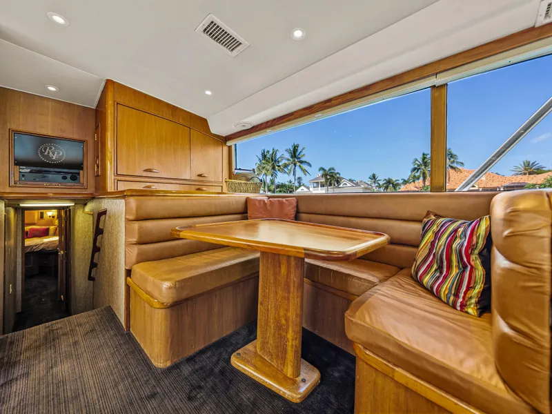 Slide: The Image of Interior of 1990 Buddy Davis 61 Convertible yacht with dining area and large windows. - 15