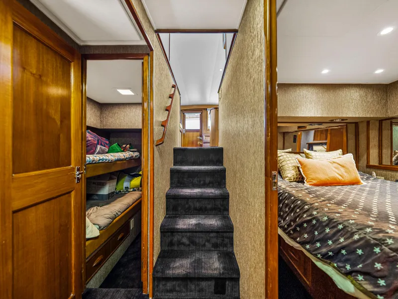 Slide: The Image of Interior of 1990 Buddy Davis 61 Convertible yacht with stairs, bunk beds, and master bedroom. - 16