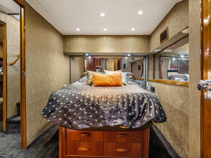 Slide: The Image of Luxurious bedroom interior of 1990 Buddy Davis 61 Convertible yacht with cozy bedding. - 17