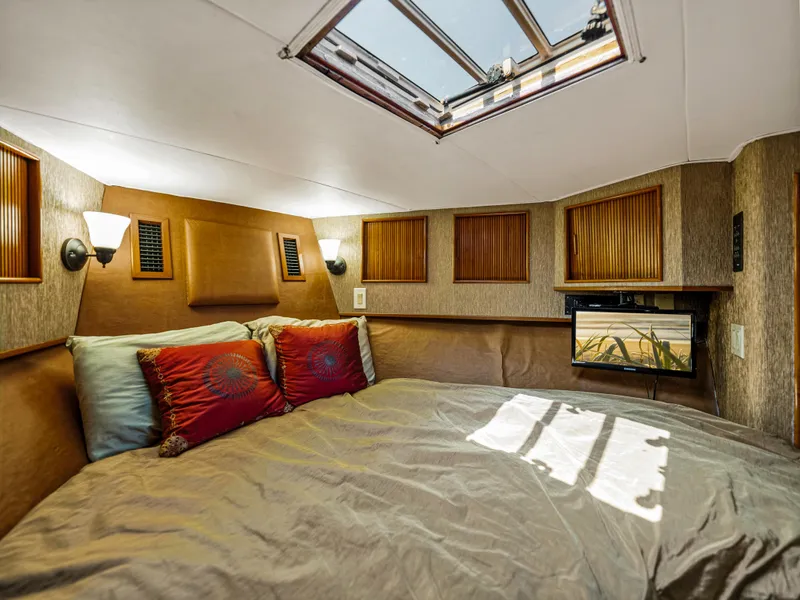 Slide: The Image of Cozy bedroom in 1990 Buddy Davis 61 Convertible yacht with skylight and TV. - 21