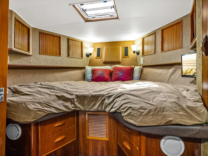 Slide: The Image of Cozy bedroom in 1990 Buddy Davis 61 Convertible yacht with wood accents and skylight. - 22