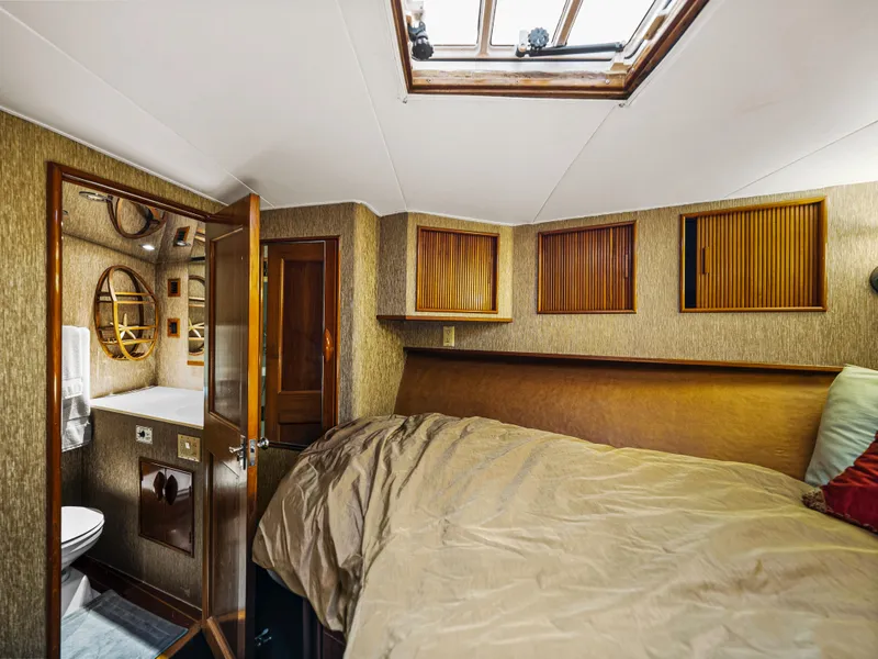 Slide: The Image of Interior cabin of a 1990 Buddy Davis 61 Convertible yacht with bed and bathroom. - 23