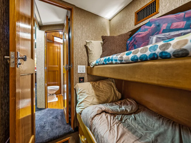 Slide: The Image of Interior cabin of 1990 Buddy Davis 61 Convertible with bunk beds and bathroom. - 25