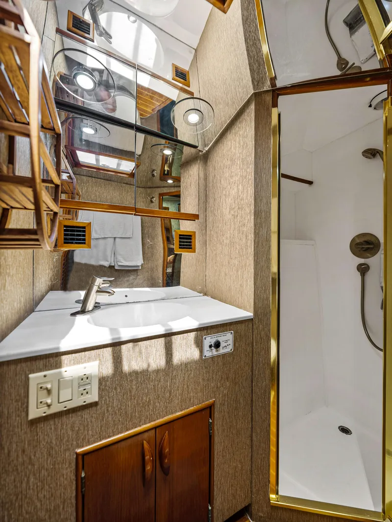Slide: The Image of Bathroom interior of a 1990 Buddy Davis 61 Convertible yacht with sink and shower. - 27