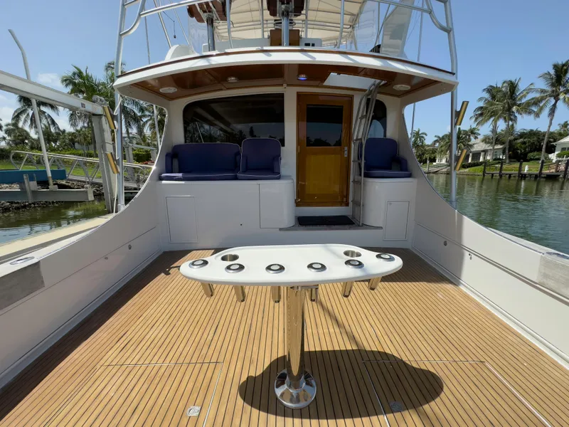 Slide: The Image of 1990 Buddy Davis 61 Convertible yacht deck with fishing rod holders. - 29