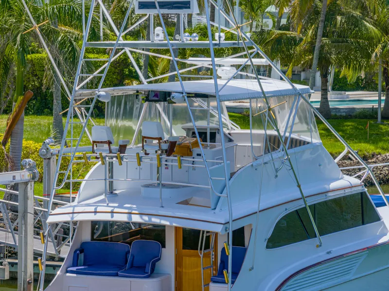 Slide: The Image of 1990 Buddy Davis 61 Convertible yacht with flybridge and fishing chairs docked. - 3