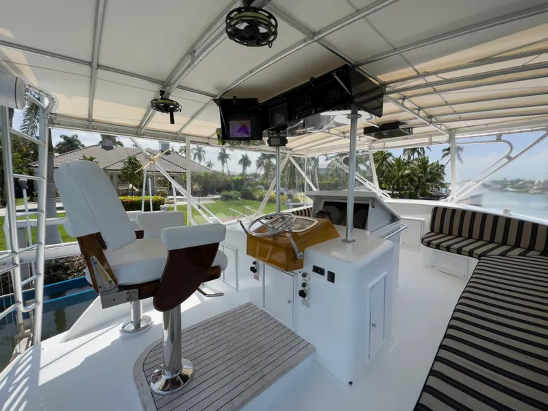 Slide: The Image of Interior of 1990 Buddy Davis 61 Convertible yacht with helm station and seating area. - 35