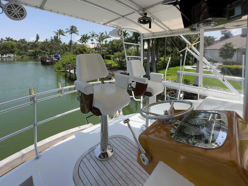 Slide: The Image of 1990 Buddy Davis 61 Convertible yacht helm station with scenic waterfront view. - 36