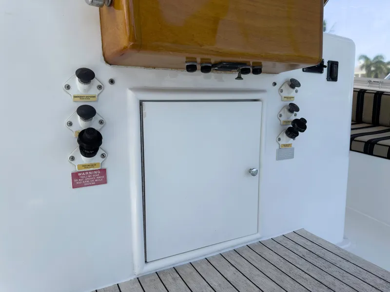 Slide: The Image of 1990 Buddy Davis 61 Convertible boat control panel and storage compartment. - 38