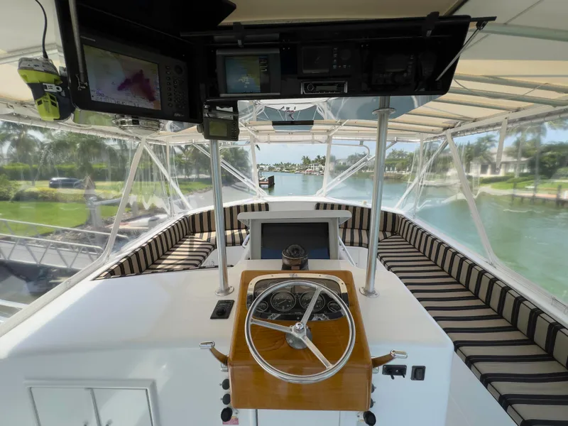 Slide: The Image of 1990 Buddy Davis 61 Convertible yacht helm with striped seating and navigation equipment. - 40