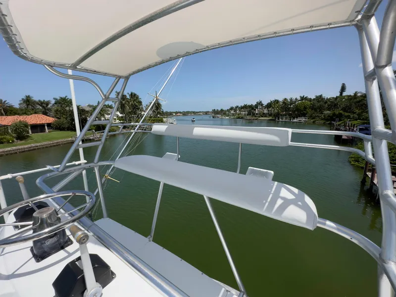 Slide: The Image of View from the helm of a 1990 Buddy Davis 61 Convertible yacht on a serene waterway. - 47