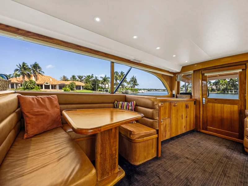 Slide: The Image of Interior of 1990 Buddy Davis 61 Convertible yacht with wooden furnishings and waterfront view. - 9