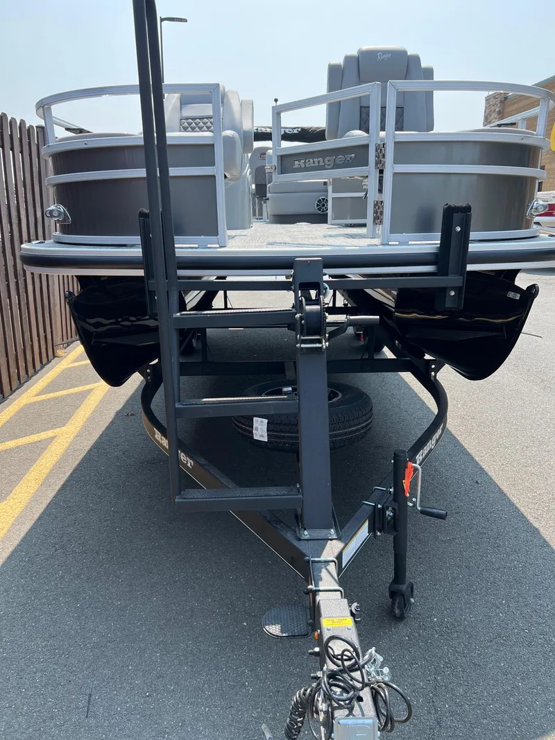 Slide: The Image of 2024 Ranger Reata 220F pontoon boat on trailer, front view. - 2