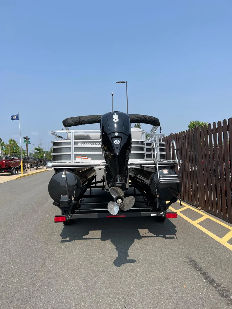 Slide: The Image of 2024 Ranger Reata 220F pontoon boat on trailer, rear view. - 3